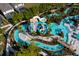 Aerial view of the community's lazy river, pool, and surrounding landscaping at 136 Jetty Way, Davenport, FL 33897