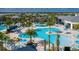 Aerial view of the community pool with ample seating, umbrellas, and lush landscaping at 136 Jetty Way, Davenport, FL 33897