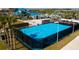 Outdoor blue basketball court with surrounding fence and lush landscaping, perfect for recreational activities at 136 Jetty Way, Davenport, FL 33897