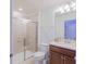 Tiled bathroom featuring a glass shower and a white toilet at 136 Jetty Way, Davenport, FL 33897