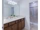 Modern bathroom featuring a double vanity, bright lighting, and a glass-enclosed shower at 136 Jetty Way, Davenport, FL 33897