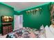 This bedroom has green walls, LED lighting, and a dinosaur-themed bedspread at 136 Jetty Way, Davenport, FL 33897