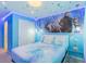 Lovely bedroom with a bed, ambient lights, and Frozen-themed decor at 136 Jetty Way, Davenport, FL 33897