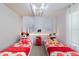Charming bedroom featuring two twin beds with playful Mickey Mouse decor and themed lighting at 136 Jetty Way, Davenport, FL 33897