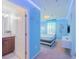 Cozy view from the hallway to a Frozen-themed bedroom with blue lighting and decorations at 136 Jetty Way, Davenport, FL 33897