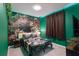 This dinosaur-themed bedroom has green walls and an accent wall featuring dinosaurs at 136 Jetty Way, Davenport, FL 33897