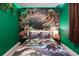 The bedroom features dinosaur-themed décor and green LED lighting, creating a fun, immersive atmosphere at 136 Jetty Way, Davenport, FL 33897