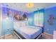 Charming bedroom with a Frozen-themed mural, snowflake decor, and soft blue lighting at 136 Jetty Way, Davenport, FL 33897