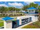 This community sign for Windsor Island Resort features lush landscaping, palm trees, and blue accents at 136 Jetty Way, Davenport, FL 33897