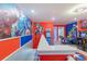 Fun game room with superhero-themed murals and a variety of arcade games at 136 Jetty Way, Davenport, FL 33897