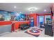 Amusing game room featuring superhero decor, arcade games, a sofa, and a Captain America rug at 136 Jetty Way, Davenport, FL 33897