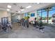Well-equipped gym with modern fitness equipment, large windows, and a view of the community pool at 136 Jetty Way, Davenport, FL 33897