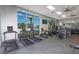 Bright gym featuring treadmills and various fitness equipment, offering a view of the outdoor pool at 136 Jetty Way, Davenport, FL 33897