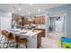 Bright kitchen featuring an island with seating, stainless steel appliances, and ample counter space at 136 Jetty Way, Davenport, FL 33897