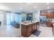 Open concept kitchen flows to the living area, featuring a large island with stainless appliances at 136 Jetty Way, Davenport, FL 33897