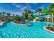 Beautiful resort-style lazy river with water slides, lifeguard station, and lush tropical landscaping at 136 Jetty Way, Davenport, FL 33897