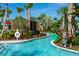 Beautiful lazy river with lush landscaping and convenient cabana areas at 136 Jetty Way, Davenport, FL 33897