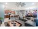 Open-concept living area with modern kitchen, comfortable seating, and stylish decor, great for entertaining at 136 Jetty Way, Davenport, FL 33897