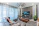 Modern living room with stylish decor, sleek furniture, and bright natural light from large windows at 136 Jetty Way, Davenport, FL 33897