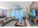 Comfortable living room with large windows, stylish sectional, and unique decor, perfect for relaxing at 136 Jetty Way, Davenport, FL 33897