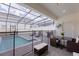 Inviting outdoor living space featuring a dining set, lounge chairs, and a secure pool area at 136 Jetty Way, Davenport, FL 33897