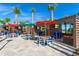 Outdoor patio featuring ample seating, televisions, and colorful umbrellas for a relaxing experience at 136 Jetty Way, Davenport, FL 33897