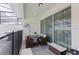 Stylish patio area with modern outdoor furniture, dining space, and view of the private pool at 136 Jetty Way, Davenport, FL 33897