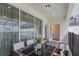 Covered patio with sliding glass doors, a dining table, and comfortable seating for enjoying the outdoors at 136 Jetty Way, Davenport, FL 33897