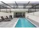 Beautiful screened-in pool with lounge chairs and outdoor grill, perfect for relaxation and entertainment at 136 Jetty Way, Davenport, FL 33897