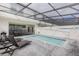 Private backyard pool with sun loungers and covered patio, ideal for relaxing and entertaining at 136 Jetty Way, Davenport, FL 33897