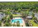 Overhead view of a community pool and recreation area with lake and mature trees at 1410 Resolute St, Celebration, FL 34747