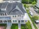 Aerial view of townhome showcasing roof, covered porch, tidy landscaping, and convenient street parking at 1410 Resolute St, Celebration, FL 34747