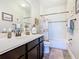 Well-maintained bathroom with a vanity, mirror, and a shower featuring a decorative curtain at 1410 Resolute St, Celebration, FL 34747