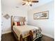 Inviting bedroom featuring hardwood floors, a decorative bed and a ceiling fan at 1410 Resolute St, Celebration, FL 34747
