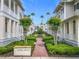 Beautifully landscaped community entrance with palm trees, manicured gardens, and inviting brick pathway at 1410 Resolute St, Celebration, FL 34747
