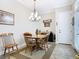 Inviting dining room with elegant chandelier and seating for four at 1410 Resolute St, Celebration, FL 34747