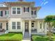 Charming two-story townhome featuring a welcoming front porch, manicured landscaping, and a classic design at 1410 Resolute St, Celebration, FL 34747