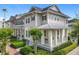 Attractive townhome showcasing a covered front porch, well-maintained landscaping, and a welcoming curb appeal at 1410 Resolute St, Celebration, FL 34747