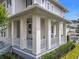 Inviting front porch with sturdy columns, white railings, and lush greenery providing a tranquil outdoor space at 1410 Resolute St, Celebration, FL 34747