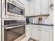 Modern kitchen showing built in stainless steel oven and microwave with updated cabinets and countertops at 1410 Resolute St, Celebration, FL 34747