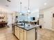 Open kitchen with a center island, stainless steel appliances, and seamless flow to the living area at 1410 Resolute St, Celebration, FL 34747