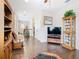 Open living room with hardwood floors, comfortable seating, and a decorative cabinet at 1410 Resolute St, Celebration, FL 34747