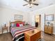 Comfortable main bedroom with hardwood floors, striped bedding, and a wooden trunk at 1410 Resolute St, Celebration, FL 34747