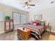 Comfortable main bedroom with hardwood floors, striped bedding, and sitting area at 1410 Resolute St, Celebration, FL 34747