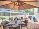 Cozy patio with brick pavers, large umbrella, and comfortable seating for outdoor enjoyment at 1410 Resolute St, Celebration, FL 34747
