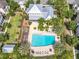 An aerial view of a community pool with palm trees, lounge chairs, and a nearby building at 1410 Resolute St, Celebration, FL 34747