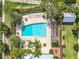 Overhead view of a community pool with lounge chairs, palm trees, and nearby community building at 1410 Resolute St, Celebration, FL 34747