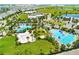 Resort-style community featuring multiple pools, palm trees, beach volleyball, and modern buildings in a beautiful, landscaped setting at 14188 Walcott Ave, Orlando, FL 32827