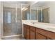 Bathroom featuring a tiled shower with a glass enclosure and a double sink vanity at 14188 Walcott Ave, Orlando, FL 32827