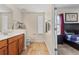 Bathroom featuring a toilet, vanity, and a doorway leading to a bedroom at 14188 Walcott Ave, Orlando, FL 32827